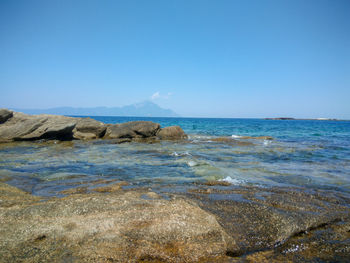 Scenic view of sea against clear blue sky