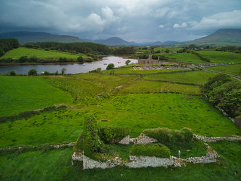 Old abbey ruins in background with a church ruins in the foreground. 