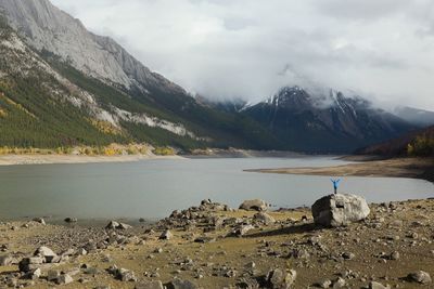 Scenic view of lake by mountains against sky