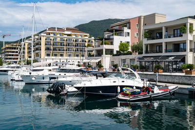 Boats in city against sky