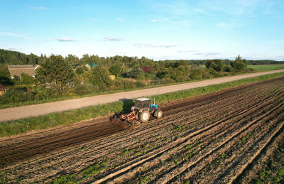 Scenic view of agricultural field against sky