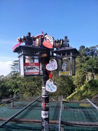 Low angle view of sign board against sky