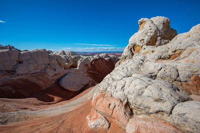 Rock formations against clear blue sky