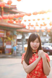 Portrait of smiling woman standing outdoors