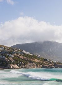 Scenic view of sea and mountains against sky