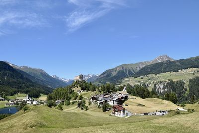 Scenic view of landscape and buildings against sky