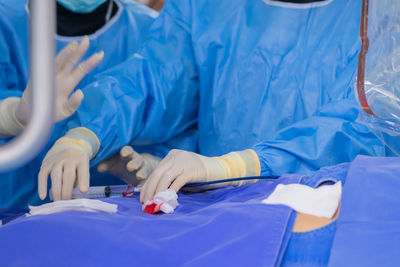 Midsection of doctor examining patient in hospital