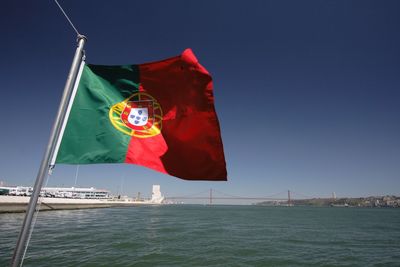 Portugal flag over calm lake