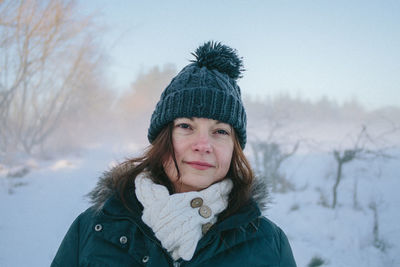 Portrait of a smiling young woman in snow