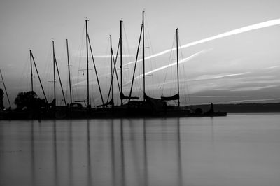 Sailboats in sea against sky