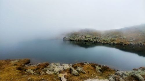 Scenic view of lake and mountains against sky