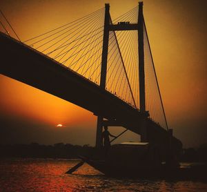 Silhouette of suspension bridge at sunset