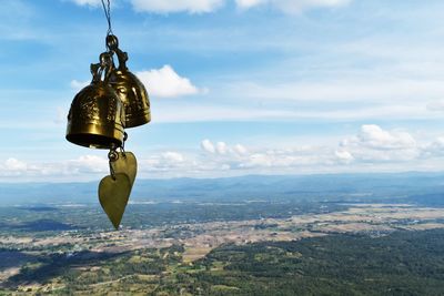 Bell and landscape against sky