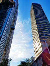 Low angle view of modern building against blue sky