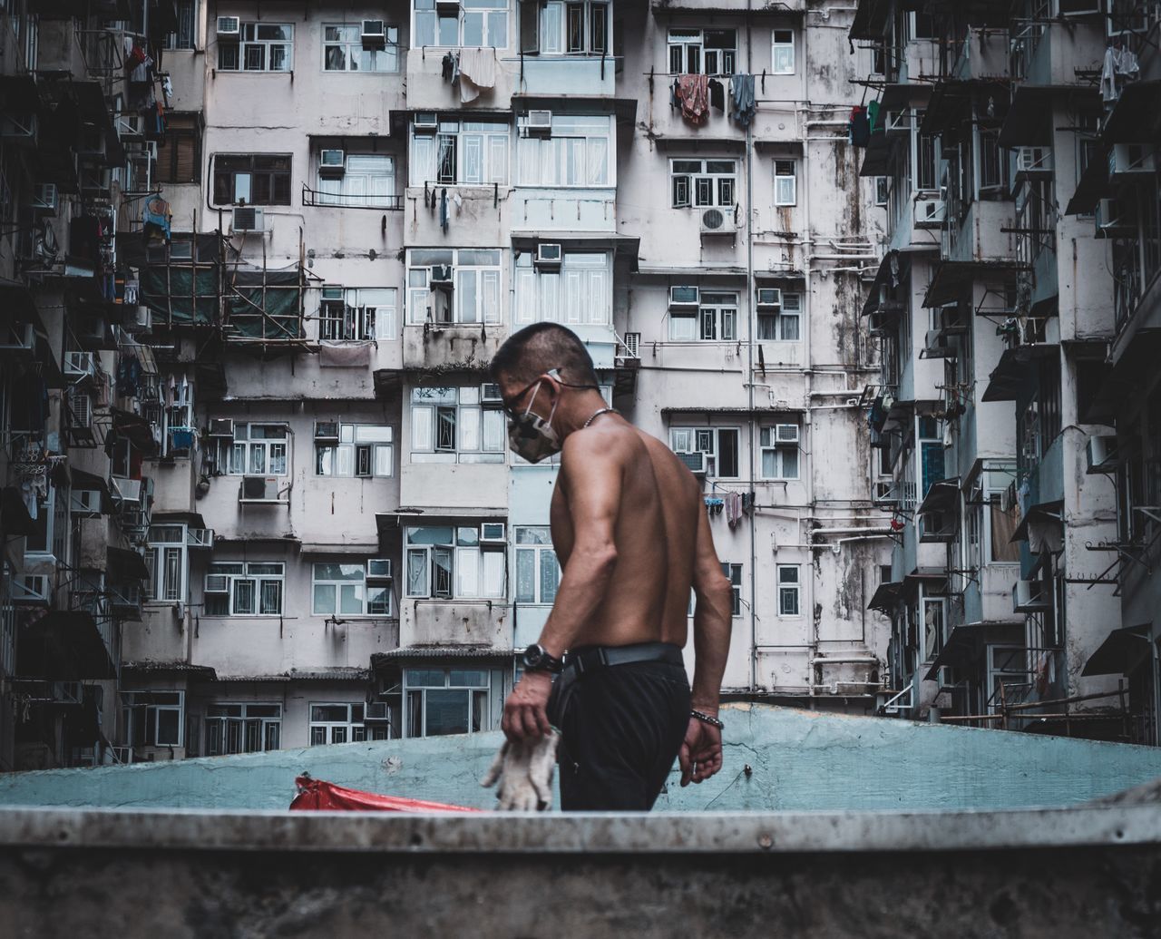 shirtless, one person, real people, men, architecture, males, mid adult, adult, young adult, lifestyles, young men, three quarter length, built structure, sitting, mid adult men, building exterior, standing, day, looking, contemplation
