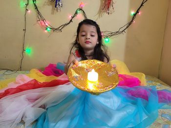 Girl looking at illuminated lighting equipment