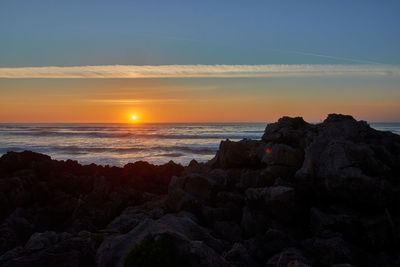 Stunning sunset of warm colors of the beach of liencres, cantrabria, spain