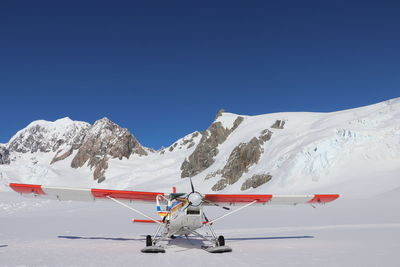 Scenic view of snowcapped mountains against clear blue sky