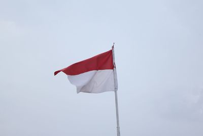 Low angle view of flag against clear sky