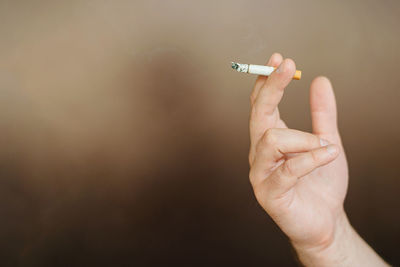 Person hand holding cigarette