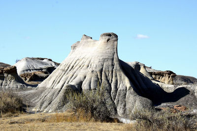 Low angle view of rock formation against clear sky