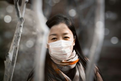 Portrait of young woman wearing mask