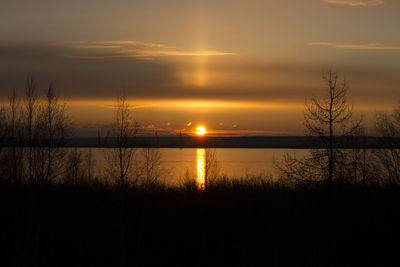 Scenic view of lake against orange sky