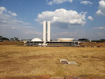 Built structure on field against sky