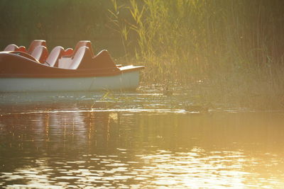 Side view of boat sailing in lake