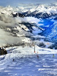 People skiing on snow covered mountain