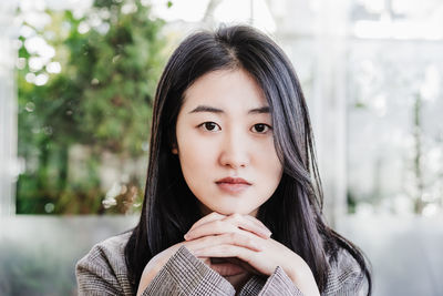 Portrait of confident professional chinese entrepreneur woman in cafeteria. technology, lifestyle