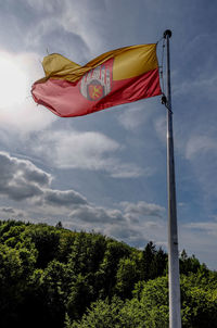 Low angle view of flags flag against sky