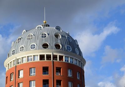 Low angle view of building against cloudy sky