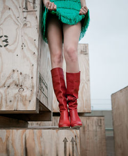 Low section of woman in skirt standing on container