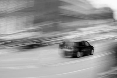 Blurred image of car moving on street