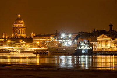 Illuminated city against sky at night