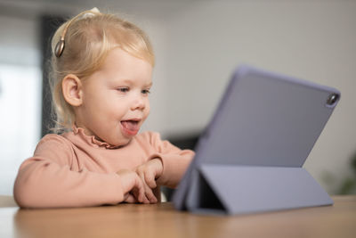 Close-up of boy using laptop at home