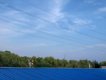 Low angle view of electricity pylon against sky