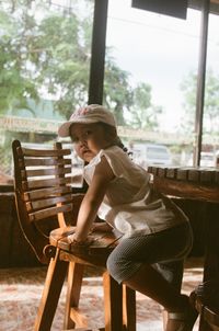 Portrait of baby girl on chair warm light 