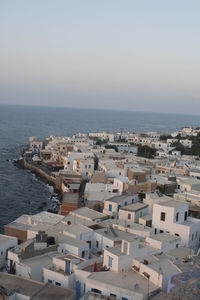 High angle view of town by sea against clear sky