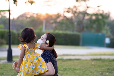 Rear view of mother and daughter