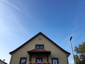 Low angle view of house against blue sky