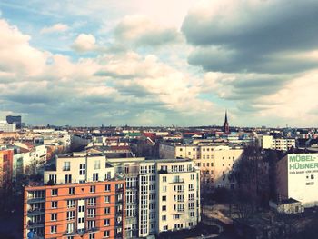 Cityscape against cloudy sky