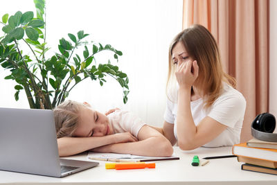 Mother helping daughter with homework