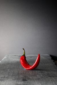 Close-up of red chili pepper against white background