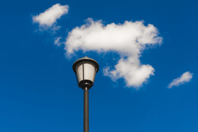 Low angle view of street light against blue sky