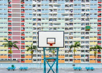Basketball hoop against building in city