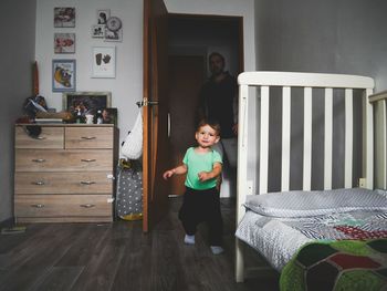 Portrait of happy girl standing in house