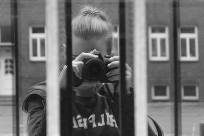 Young man photographing through camera