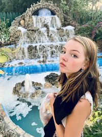 Portrait of smiling young woman in water